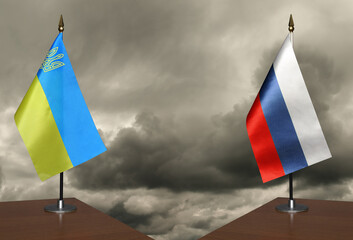 Table flags Ukraine and Russia a stormy sky in the background