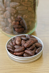 Pile of cocoa nibs on a wooden table