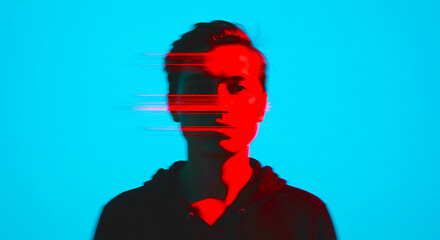 A man with red glitch effect on his face against a bright blue background in a portrait shot