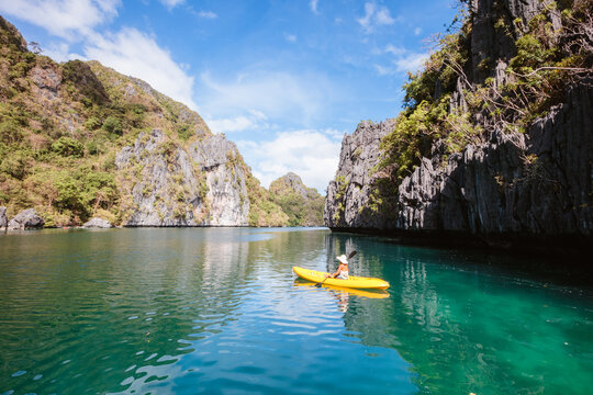 Woman paddling on a kayak at Big Lagoon, El Nido, Philippines