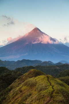 Sunset over Mayon active volcano emitting smoke, Bicol, Philippines