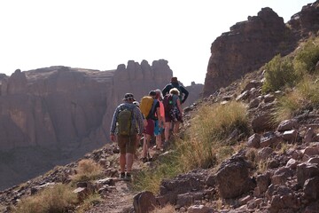 Amazing mountain landscapes of Jebel Saghro with volcanic rocks eroded by wind and time and group of trekking tourists. Atlas, Anti Atlas, Morocco © Iwona