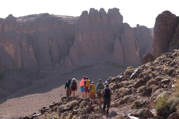 Amazing mountain landscapes of Jebel Saghro with volcanic rocks eroded by wind and time and group of trekking tourists. Atlas, Anti Atlas, Morocco © Iwona