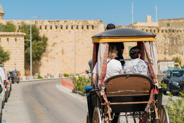 Tourists Riding Horse Carriage in Valletta Malta


