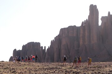 Amazing mountain landscapes of Jebel Saghro with volcanic rocks eroded by wind and time and group of trekking tourists. Atlas, Anti Atlas, Morocco © Iwona