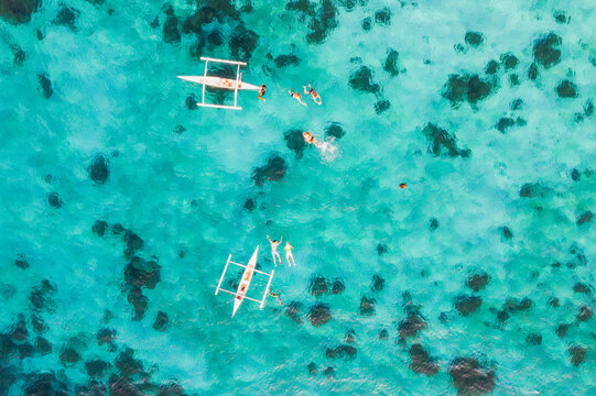 Aerial view of people swimming with sea turtle, Philippines