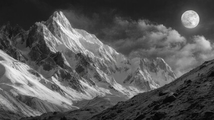 Obraz premium Majestic Snowy Mountain Peak Under a Full Moon at Night
