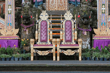 Elaborate throne chairs at a Balinese temple with colorful decorations in Indonesia