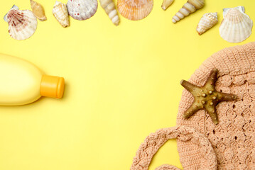 Sunscreen spray on a yellow background, starfish, handmade knitted bag and hats on a yellow background.A month to raise awareness about the safety of ultraviolet radiation.