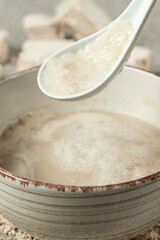 Activation of wet fresh yeast in warm water with sugar.
