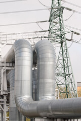 pipeline and power line against gray sky