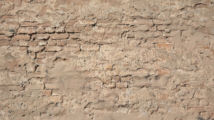 brown background, in the photo an old brick wall and old plaster