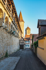 View along the city walls in the old town in Rothenburg ob der Tauber with the Weiberturm and the Röderturm
