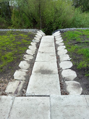 Concrete slabs for draining wastewater into a ravine during the daytime in summer.