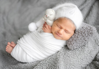 Newborn Baby Sleeping With A Smile In A Studio Photo