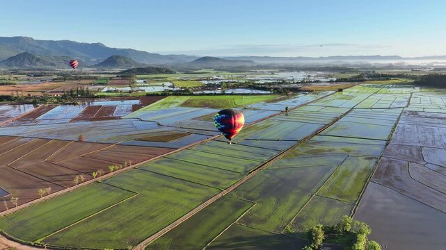 Colorful Balloon In Praia Grande Santa Catarina Brazil. Bright Colorful Hot Air Balloon Is Floating Over A Green Countryside. Deserted Outdoor Farmland Beauty. Deserted Forest.