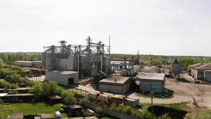 Grain elevator processing and storing harvested crops in rural landscape