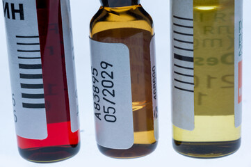 Medical ampoules close up. Pharmaceutical vials with medication. Liquid medicine in glass bottles. Healthcare and pharmacy supplies.