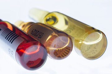 Medical ampoules on white background. Pharmaceutical vials for injection. Three glass bottles with medication.