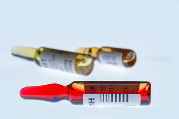 Medical ampoules for injection isolated on a white background. Transparent glass vials with clear liquid used for treatment and vaccination. Sterile pharmaceutical containers in a clinical setting.