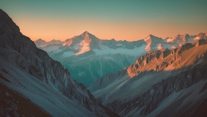 Naklejka premium Scenic mountain landscape with snow-capped peaks at sunrise or sunset. Majestic mountains and rugged terrain. Nature and outdoor adventure.