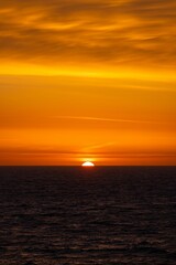 Stunning ocean sunset with vibrant orange hues.