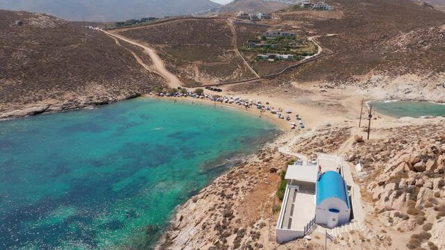 Agios Sostis Beach with turquoise waters and white chapel beside shore on Serifos island