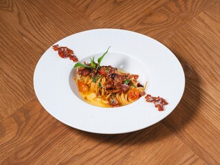 Gourmet Spaghetti Pasta with Bacon and Herbs on White Plate
