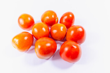 a group of red tomatoes in white background