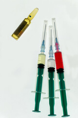 Medical syringes and ampoule on white background. Injection needles and vaccination vial. Injection accessories and medicines.