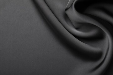 Fototapeta premium Crumpled black silk fabric as background, top view