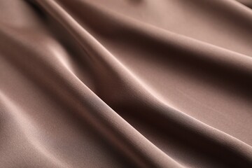 Crumpled light brown silk fabric as background, closeup