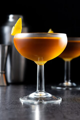 Paper plane cocktail on black slate background