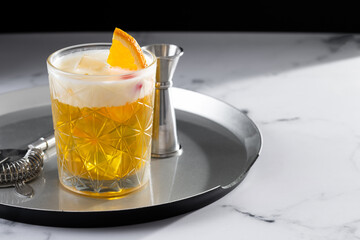 Classic cocktail whiskey sour on white marble and black background