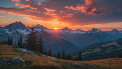 Obraz premium Sunset over mountain range with trees and grassy fields, creating a serene and picturesque landscape.