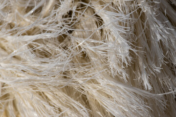 Close up of frayed white rope showing intricate fibers and texture
