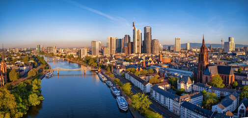 Panoramic aerial view of the skyline of Frankfurt am Main, Germany, with golden morning sunlight