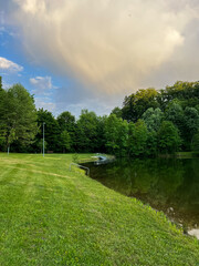 Tranquil Lakeside Park Landscape with Dramatic Sky
