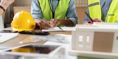 Sustainable Design Discussion. Engineers collaborating on innovative renewable energy projects in an office. © itchaznong