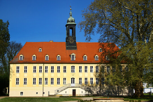 Schloss Elsterwerda with baroque architecture and clock tower under a clear blue sky in Elsterwerda, southern Brandenburg, Germany