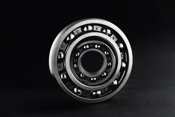 ball bearings on a black background, blank for creativity. Parts for machines and mechanisms in...