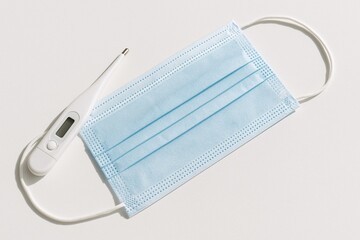 Blue Surgical Mask and Digital Thermometer for Virus Protection and Healthcare Supplies