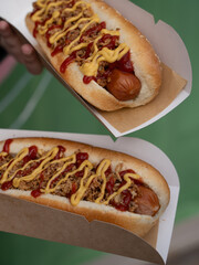 Delicious hot dogs with mustard and ketchup for take away, fast food, unhealthy 
