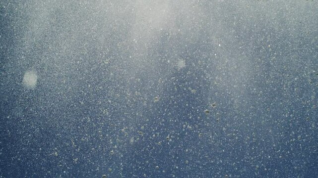 High-speed shot of water particles forming abstract misty shapes in ocean air burst
