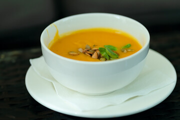 Sophisticated pumpkin soup with crunchy seeds and microgreens. Perfect vegetarian comfort food with nutritional benefits.