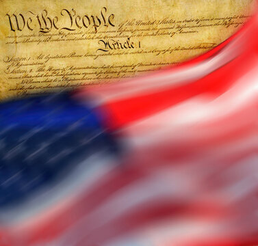 Close-up of American flag flying with Declaration of Independence