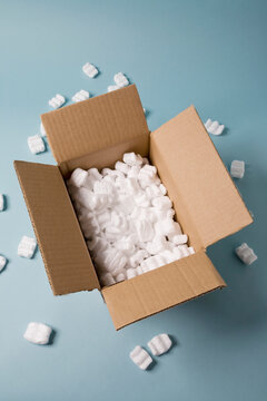 Open cardboard box filled with packing foam peanuts made of expanded polystyrene