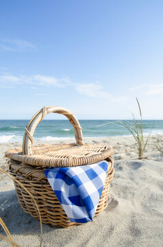 Picnic basket on sandy beach