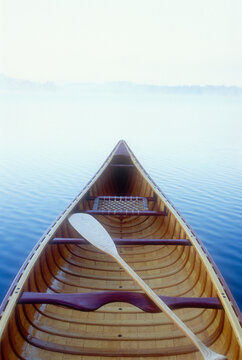 Wood canoe in morning mist on Saranac Lake