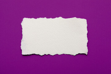 Torn paper on purple background